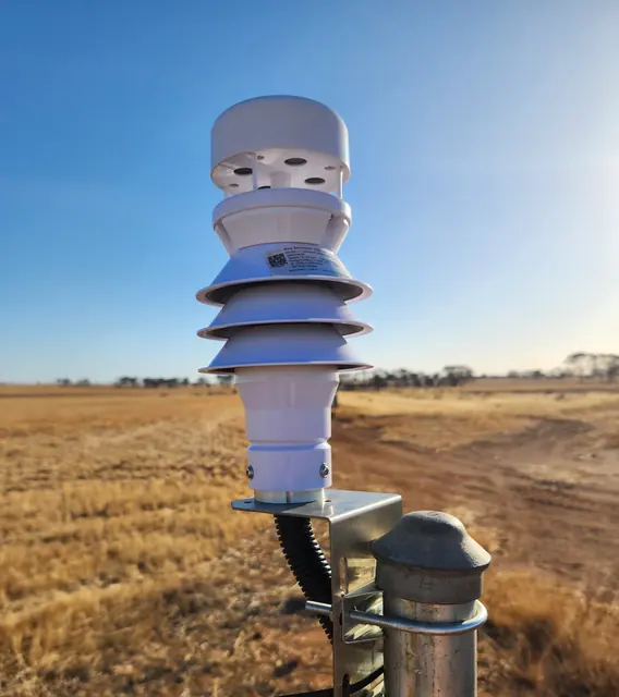 Close-up of the all-in-one ultrasonic weather sensor head on its bracket at the top of the post