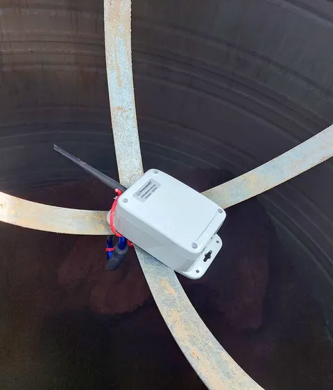 Meterra silo level sensor mounted at the top of a feed silo, looking down on the stored material