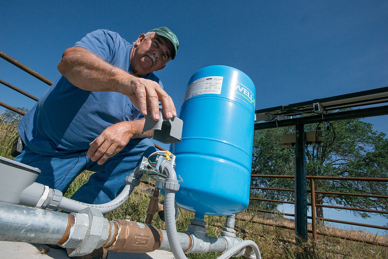 A rancher checks a solar-powered well and livestock watering system on a ranch