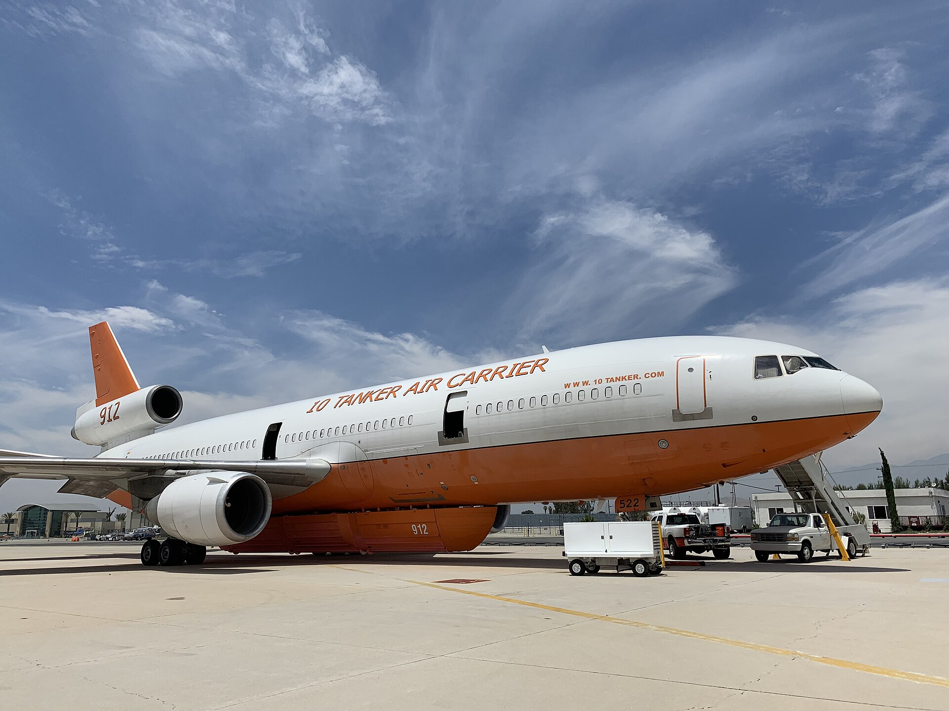 A DC-10 very large air tanker drops fire retardant on a wildfire ridge